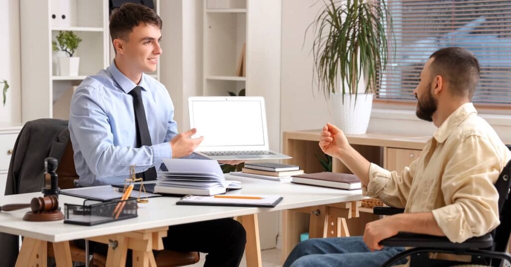 Injury victim in wheelchair meeting with a boutique personal injury lawyer | Arnold Dallas McPherson Injury Lawyers