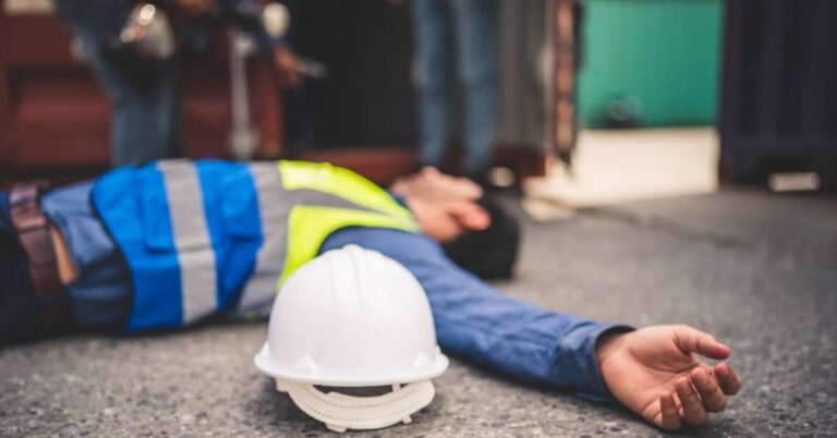 Injured worker lying on the ground after a workplace accident | Arnold Dallas McPherson Injury Lawyers